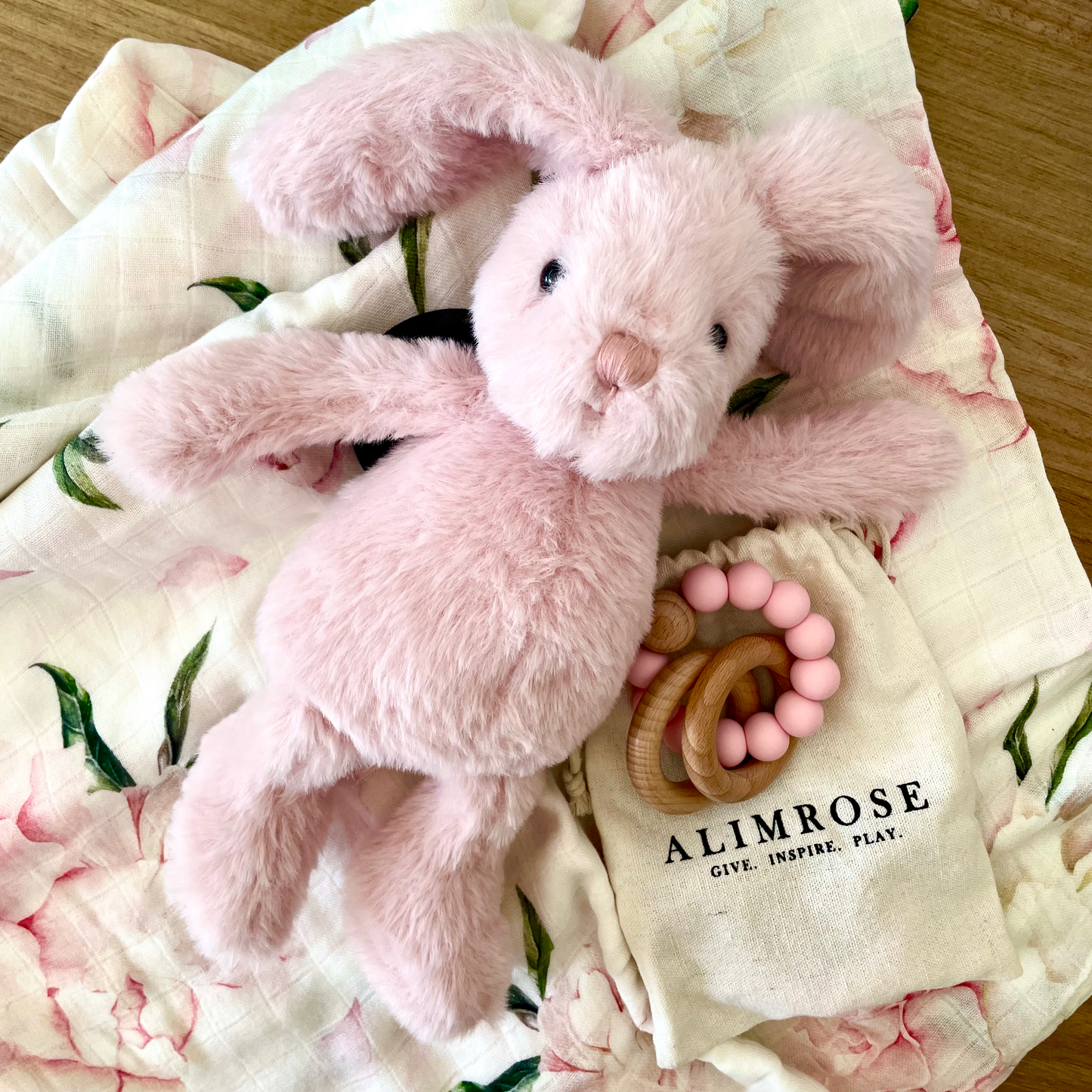 Best gift to celebrate a new baby. Pink Champagne, pink Anchor & Arrow organic swaddle. Plush pink bunny from Jiggle & Giggle, Kokopod Macadamias, Alimrose beechwood & silicon teether. Beautifully gift wrapped for new Mum and Baby. Baby girl gifts and gift boxes.